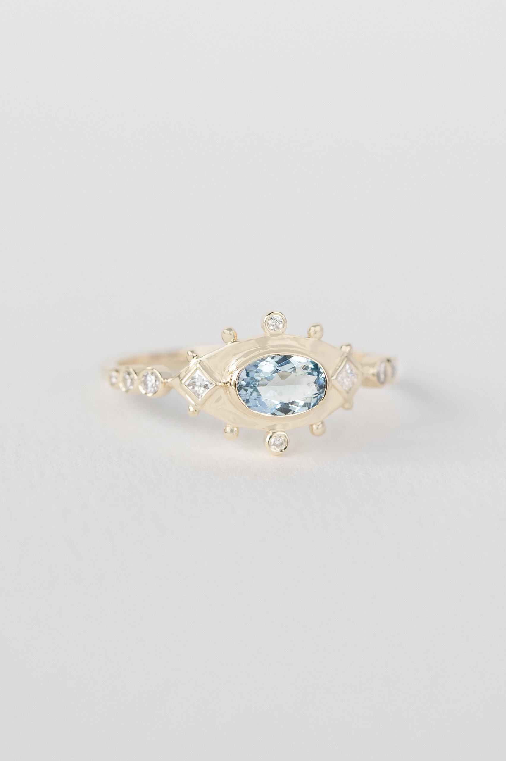 Yellow gold ring oval aquamarine diamond eye motif accents Celine Daoust