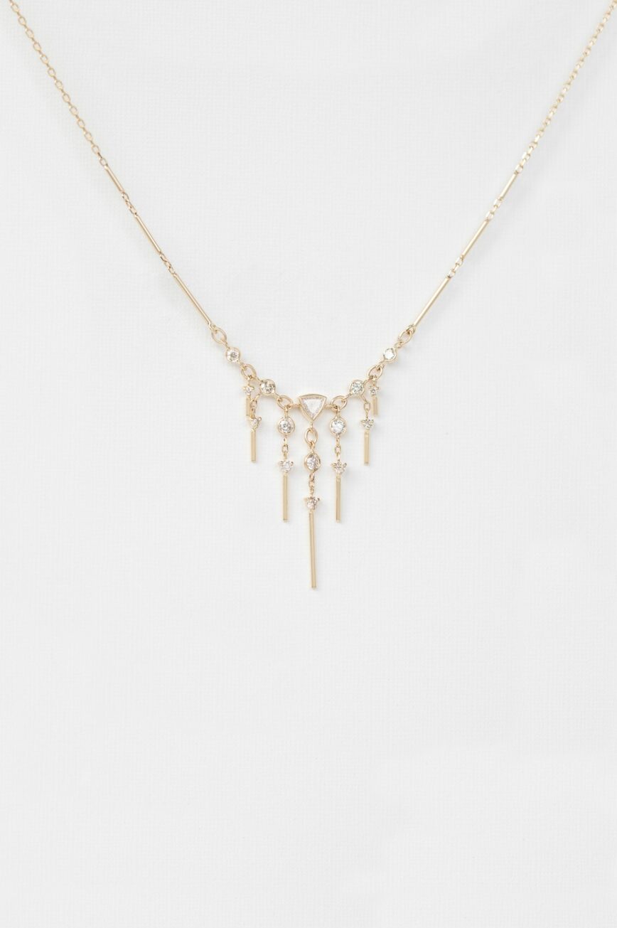 Gold necklace triangle pendant dangling diamond bar drops Celine Daoust