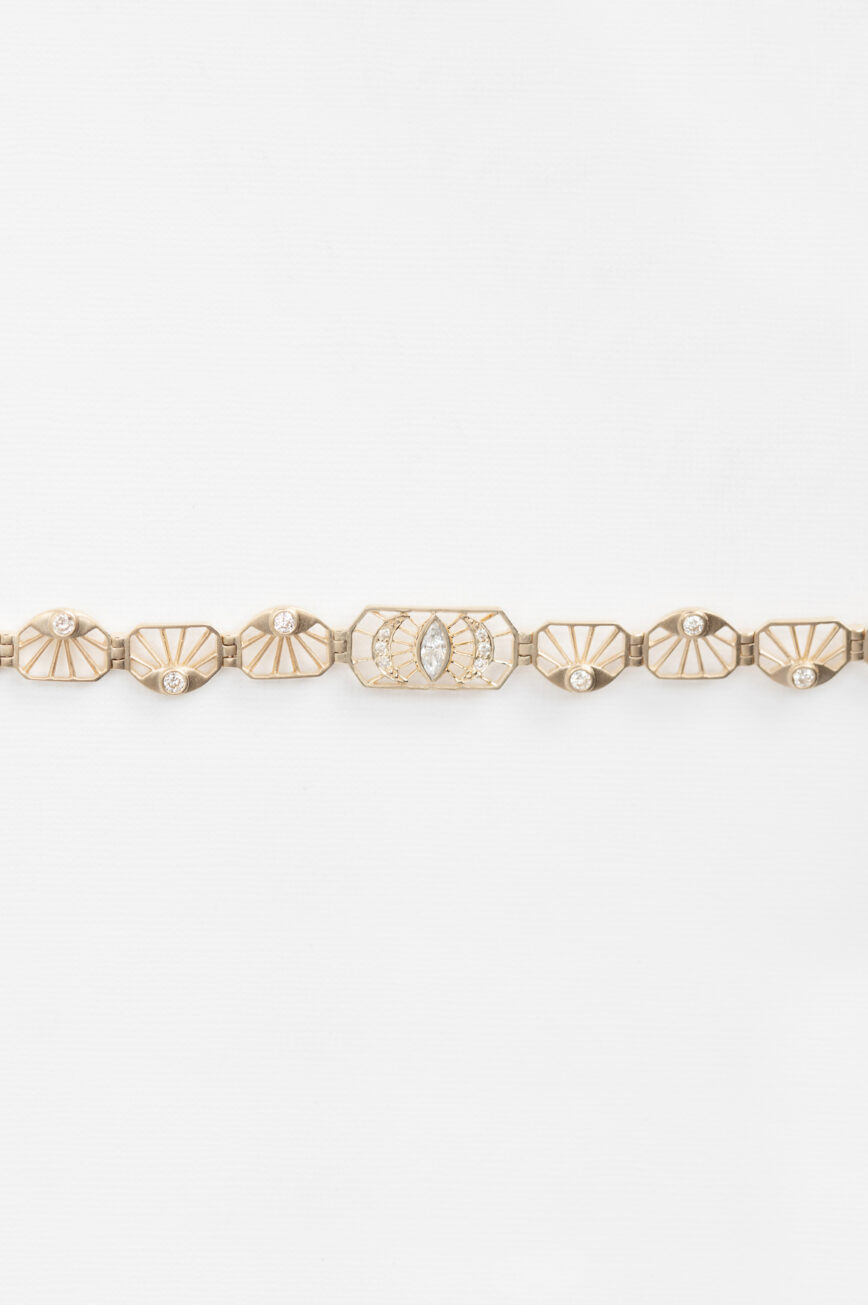 Yellow gold articulated bracelet diamond eye motif links worn on wrist Celine Daoust