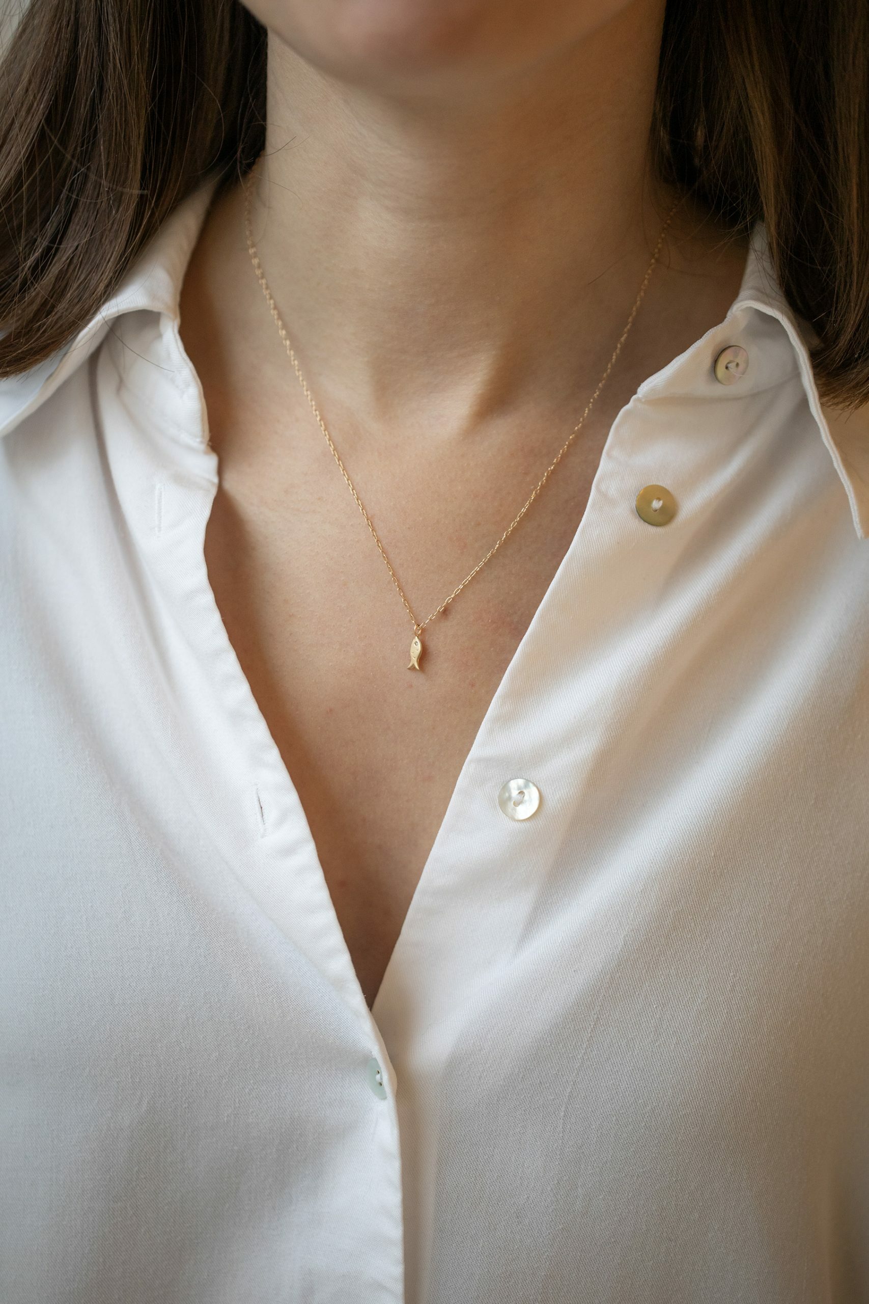 Gold necklace small fish charm pendant delicate chain Celine Daoust