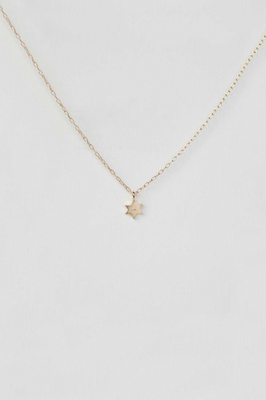 Gold necklace small star charm pendant diamond accent delicate chain Celine Daoust