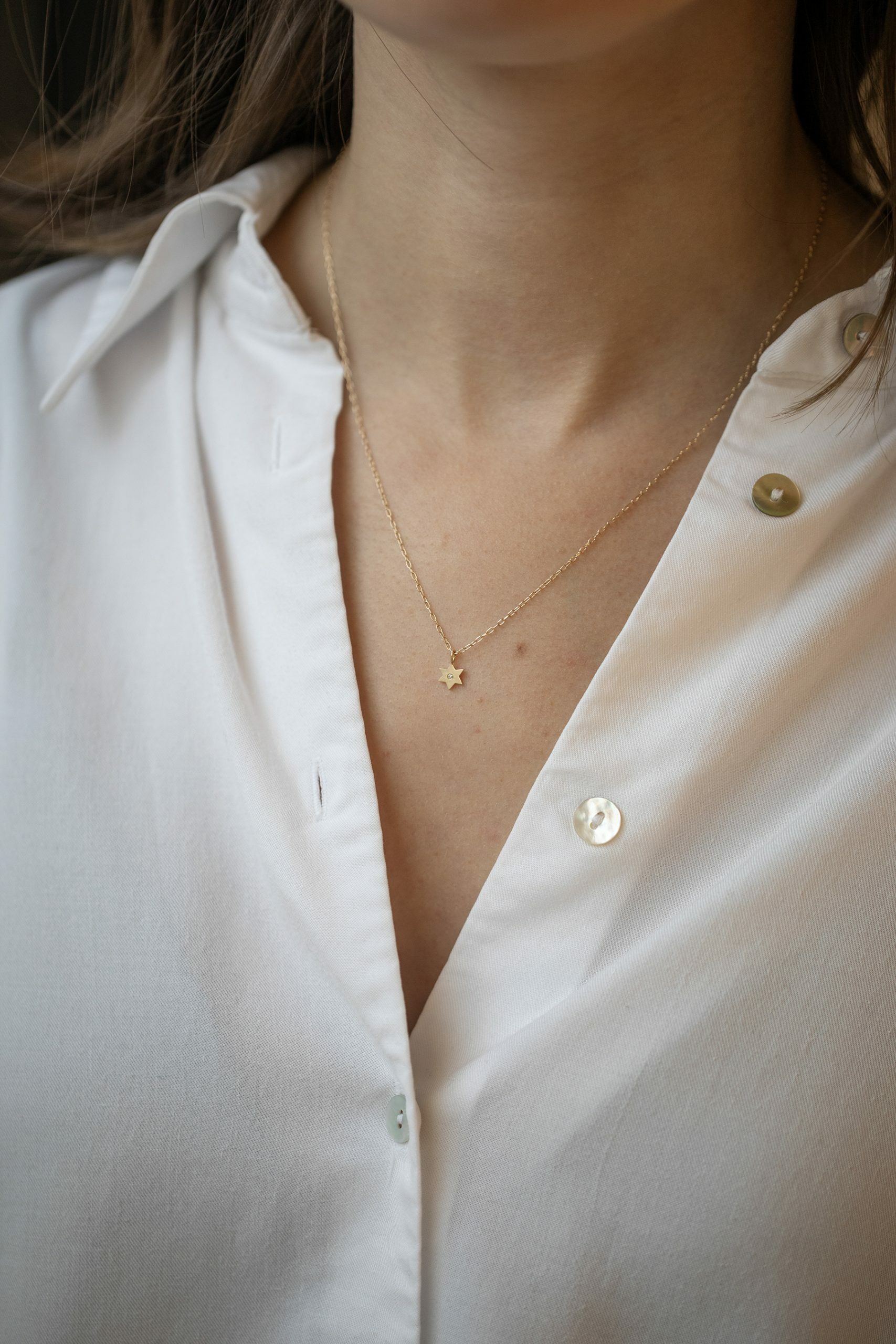 Gold necklace small star charm pendant diamond accent delicate chain Celine Daoust