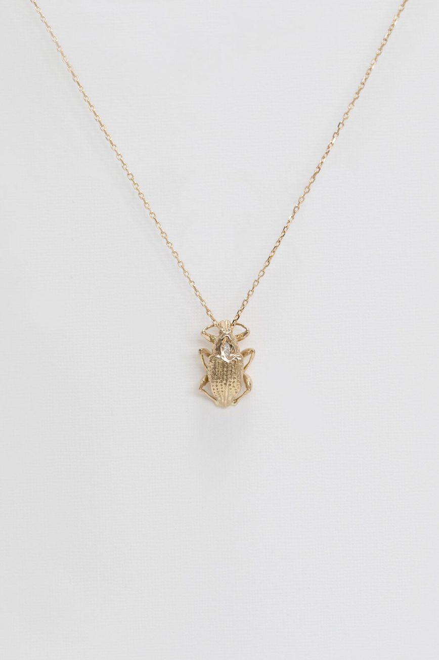 Gold necklace sculpted scarab charm marquise diamond accent Celine Daoust