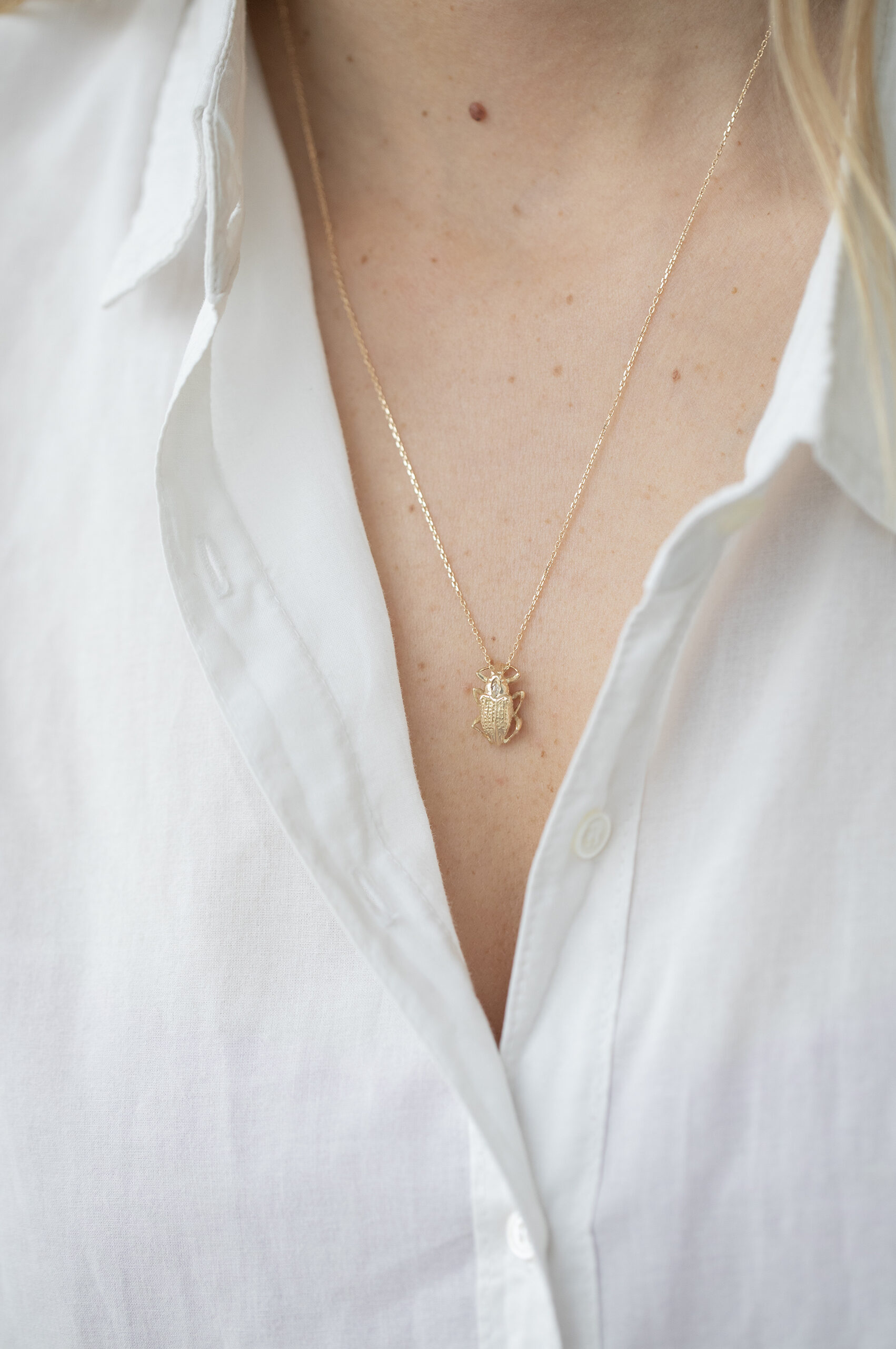 Gold necklace sculpted scarab charm marquise diamond accent Celine Daoust
