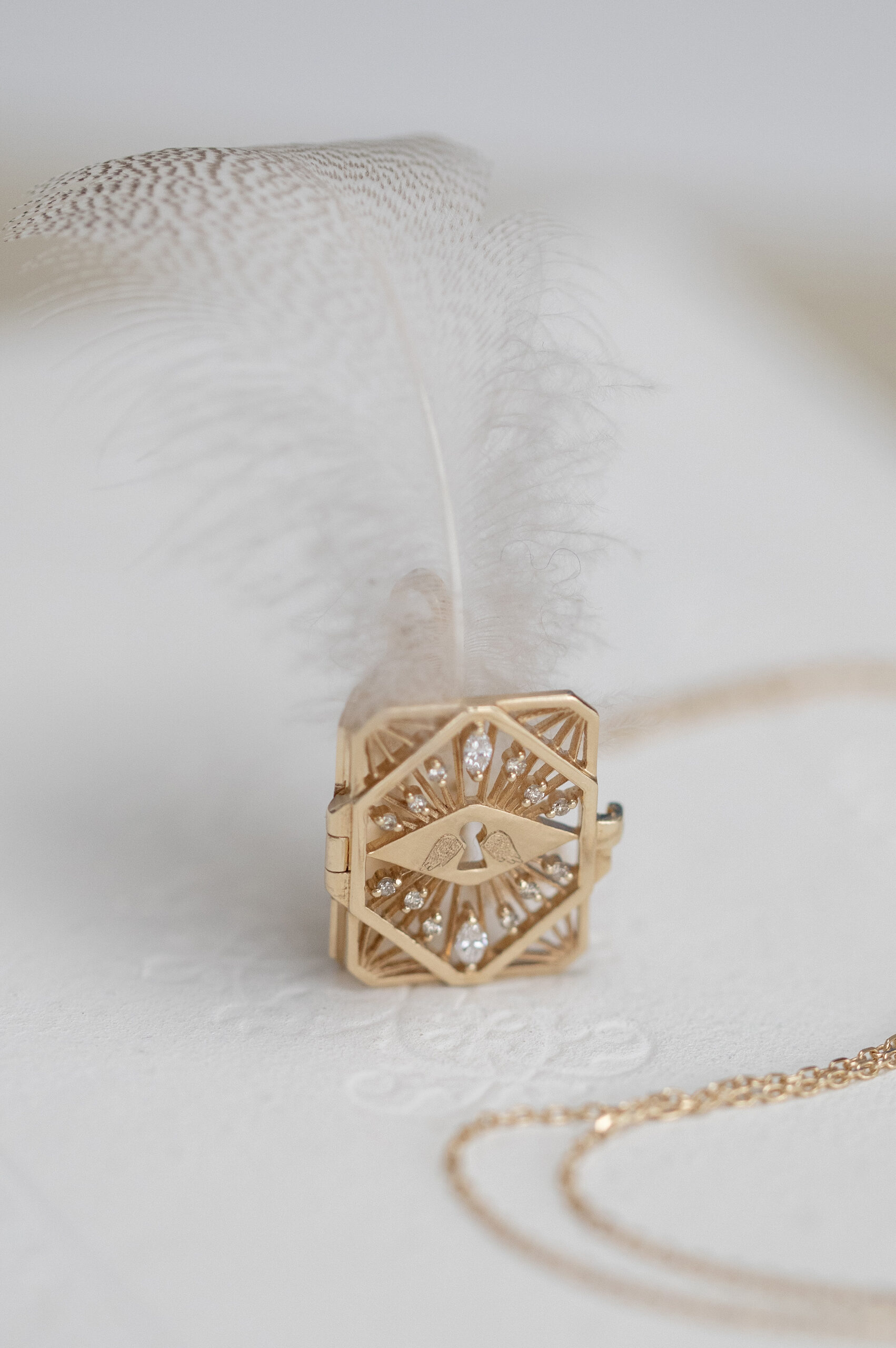 Gold necklace geometric book pendant eye motif diamond accents Celine Daoust