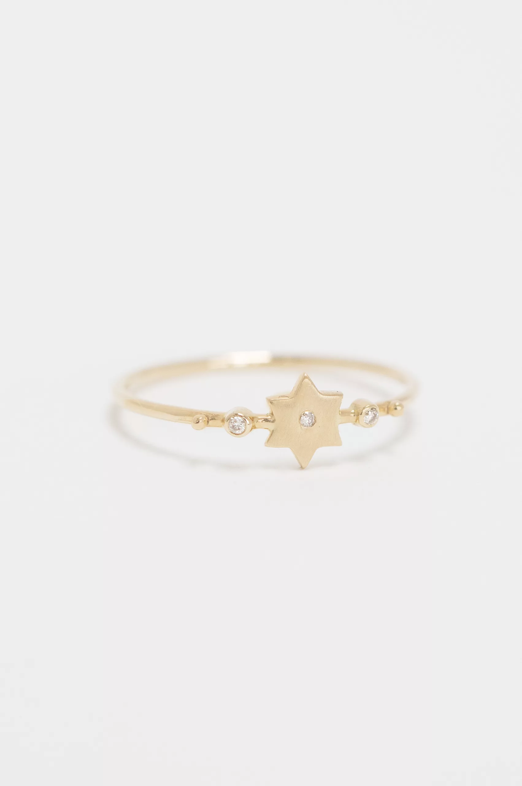 Yellow gold ring sculpted north star motif diamond accent slim band Celine Daoust