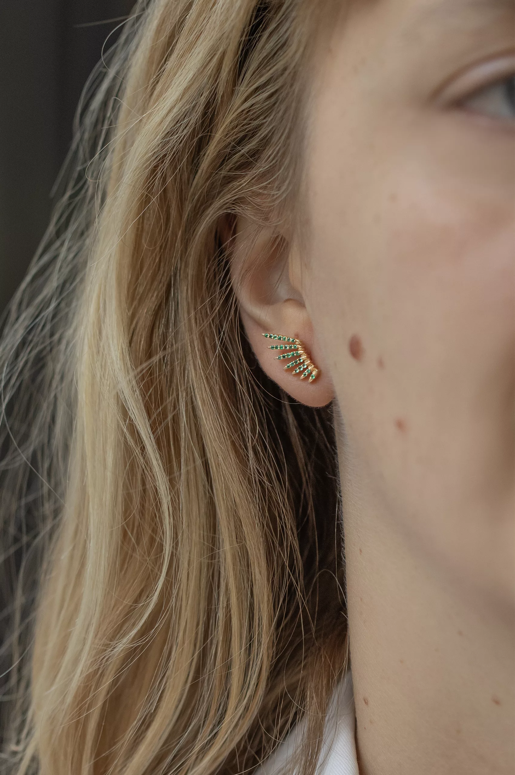 Yellow gold stud earrings sculpted wing motif pavé emerald pair Celine Daoust