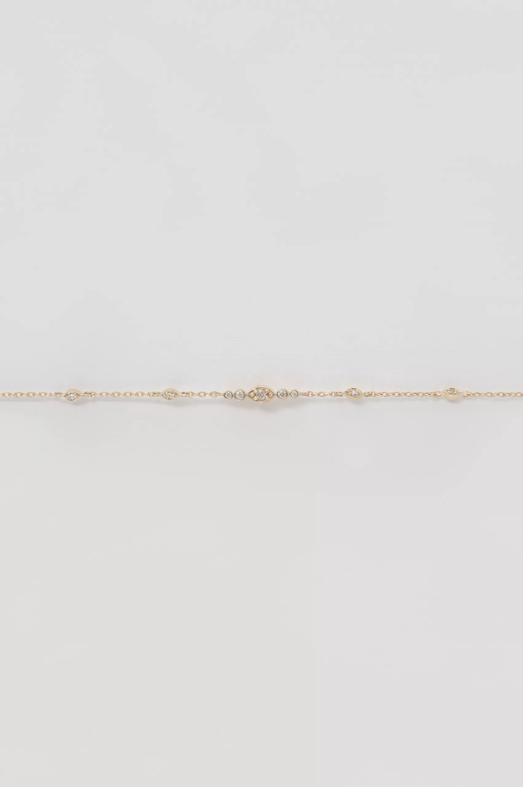 Gold chain bracelet small eye motif diamond accents Céline Daoust