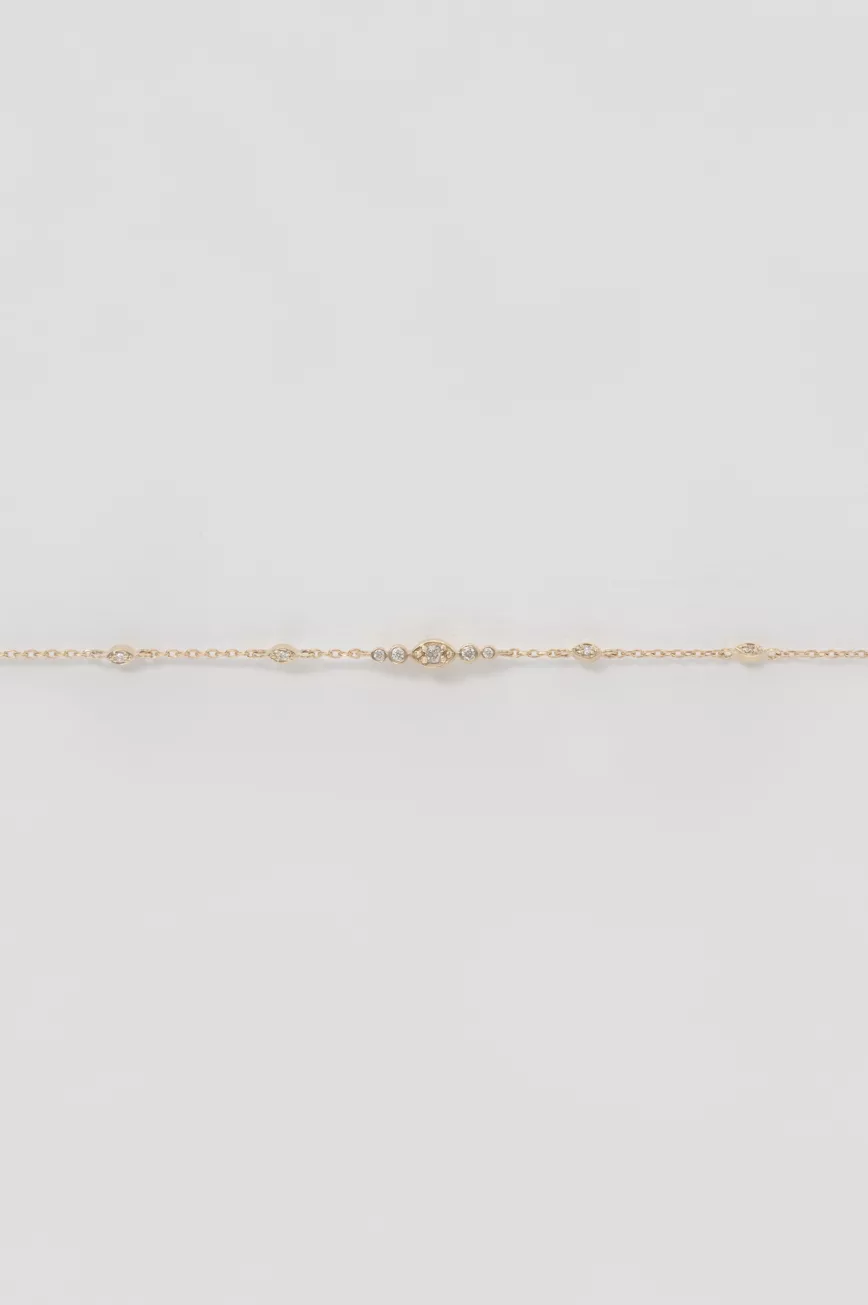 Gold chain bracelet small eye motif diamond accents Céline Daoust