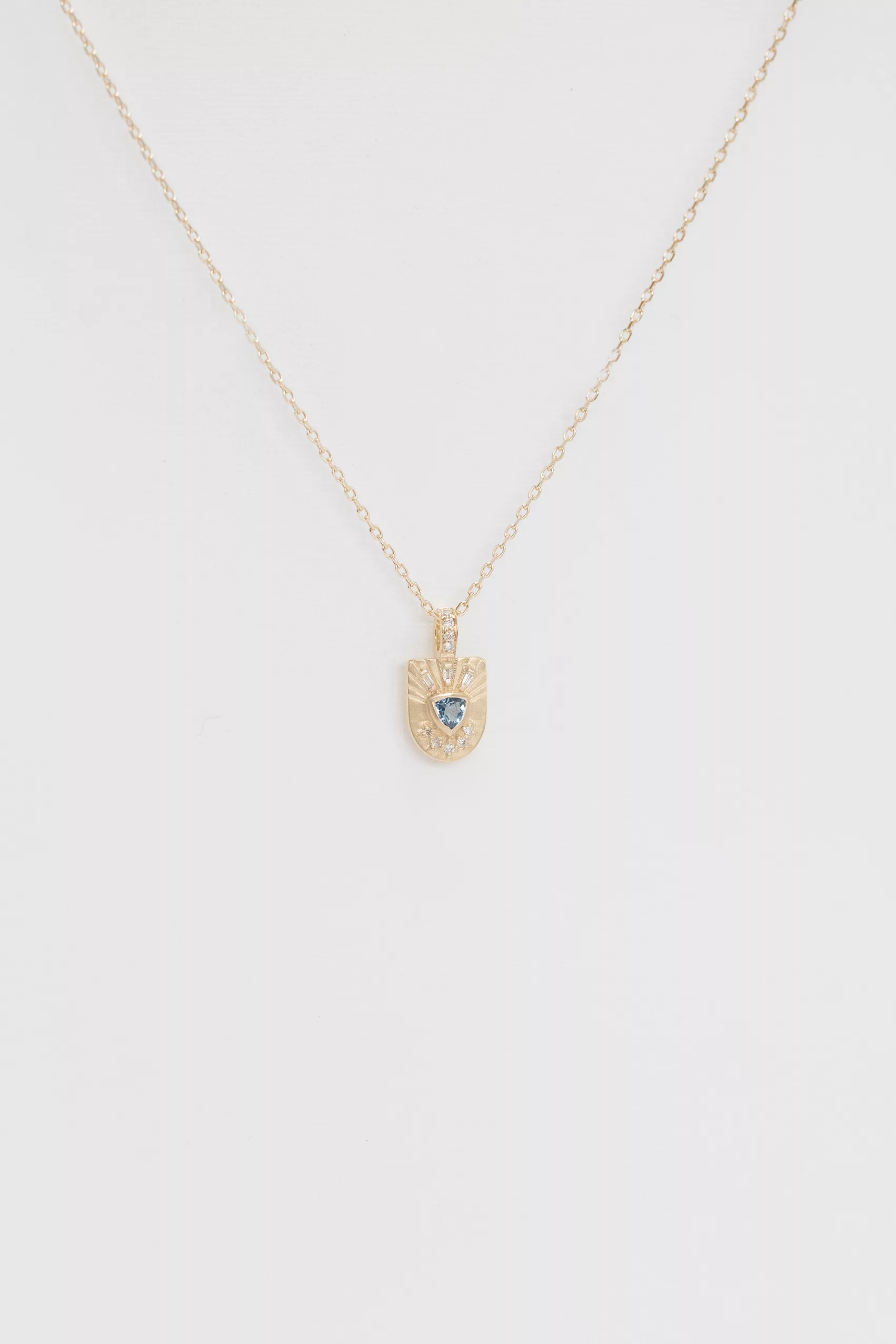 Yellow gold necklace engraved shield pendant trillion aquamarine diamond sun motif Celine Daoust