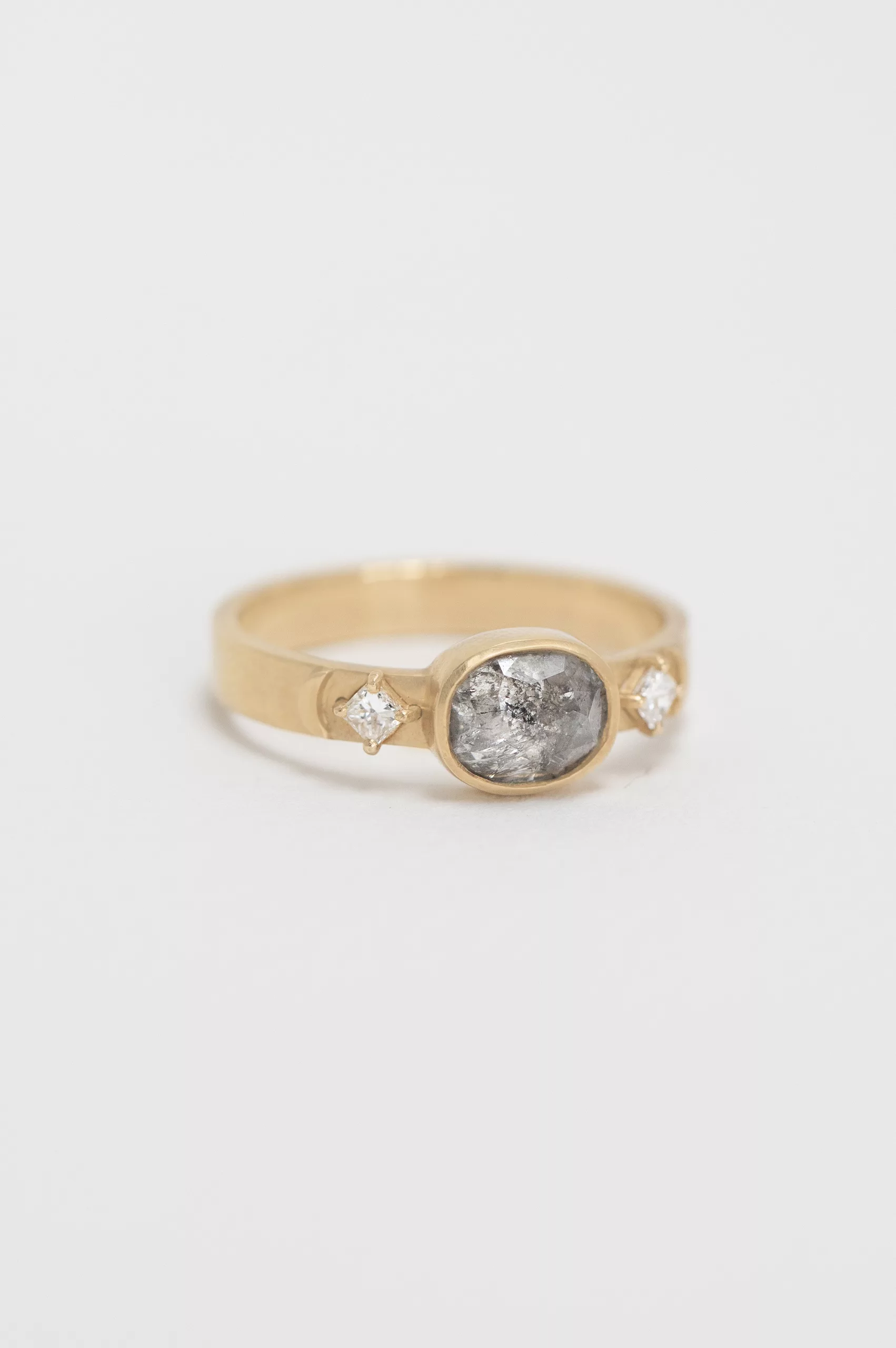 Yellow gold signet ring oval dark grey diamond square diamond side accents Celine Daoust