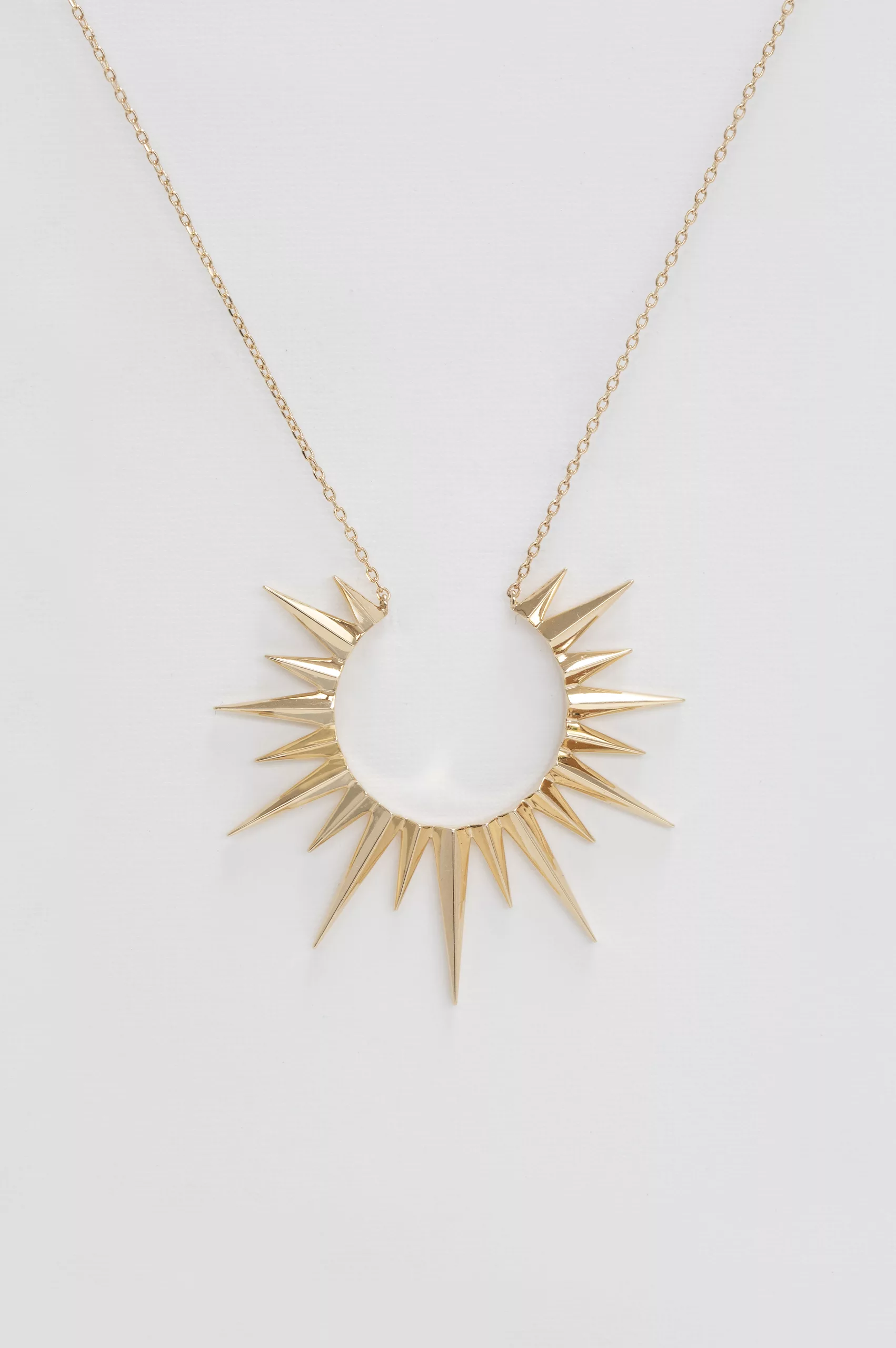 Yellow gold necklace large sun ray pendant worn on neck Celine Daoust