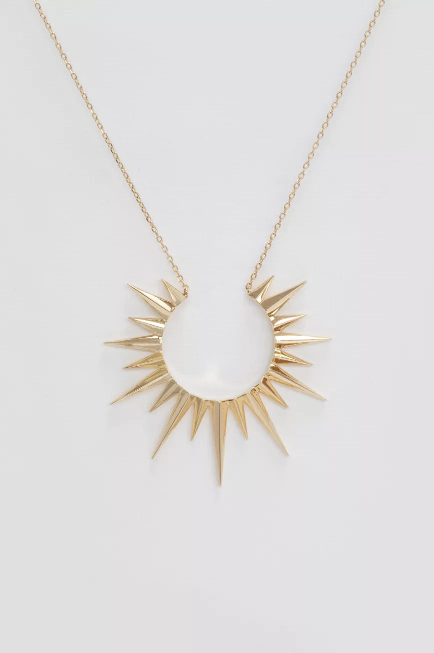 Yellow gold necklace large sun ray pendant worn on neck Celine Daoust