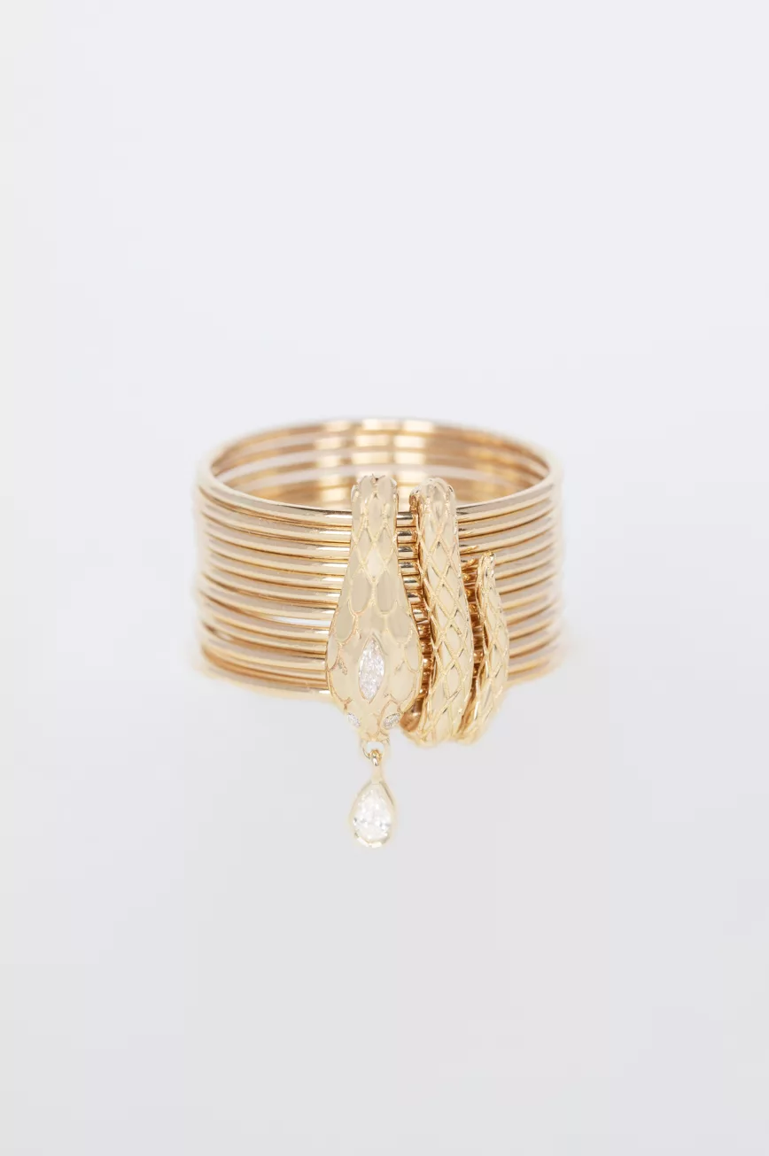 Yellow gold stacked multi-band ring sculpted cobra motif diamond drop charm Celine Daoust