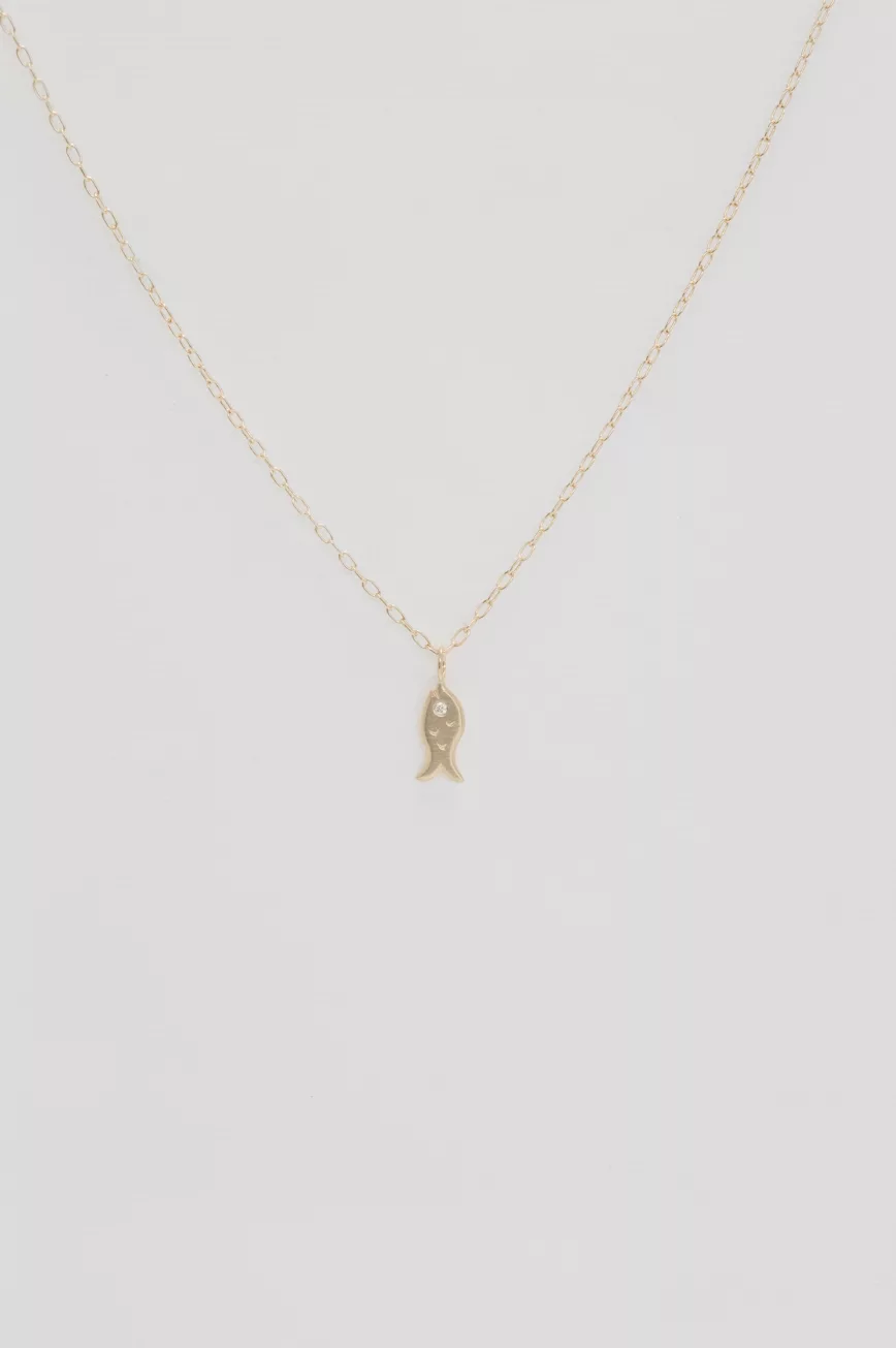 Gold necklace small fish charm pendant delicate chain Celine Daoust