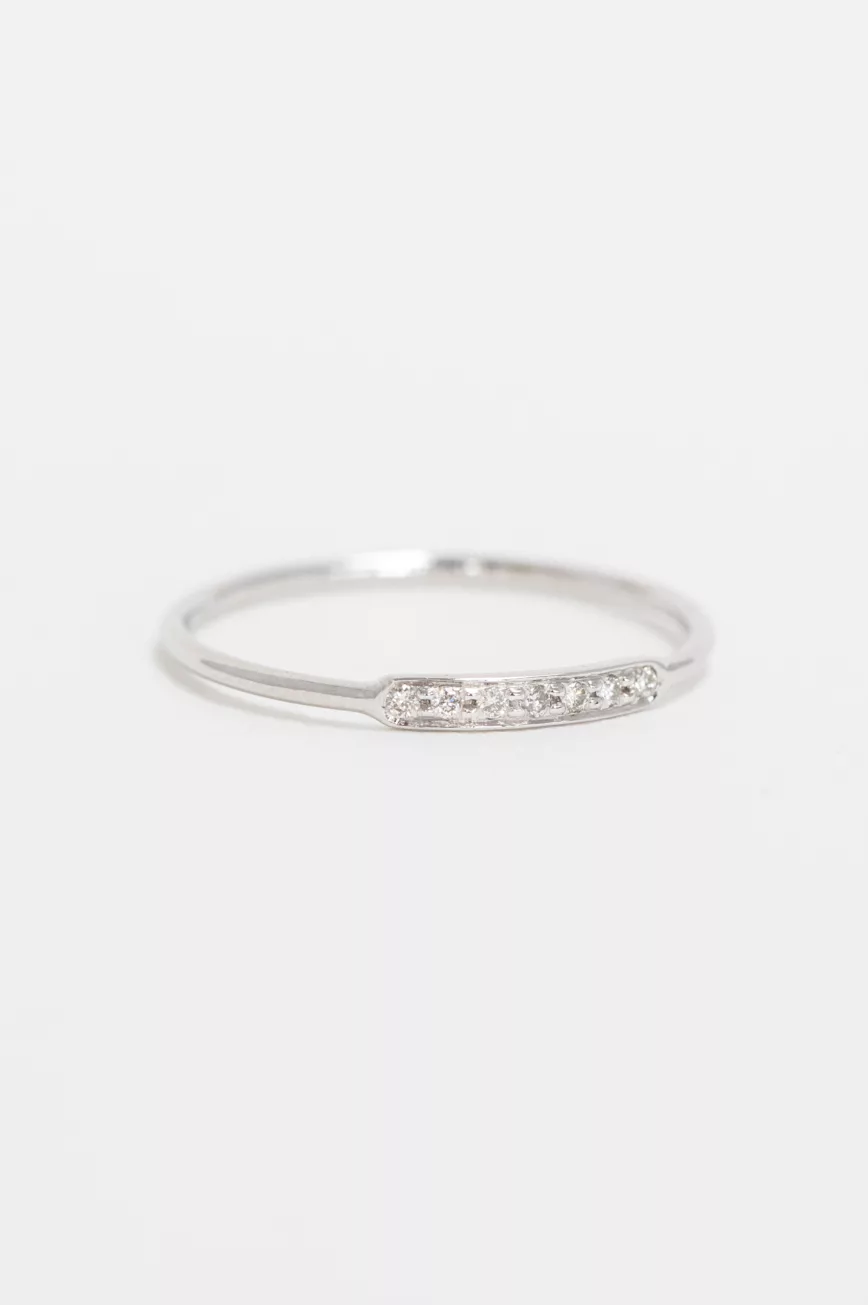white gold slim band ring featuring a central rectangular pavé bar set with a row of tiny round brilliant diamonds