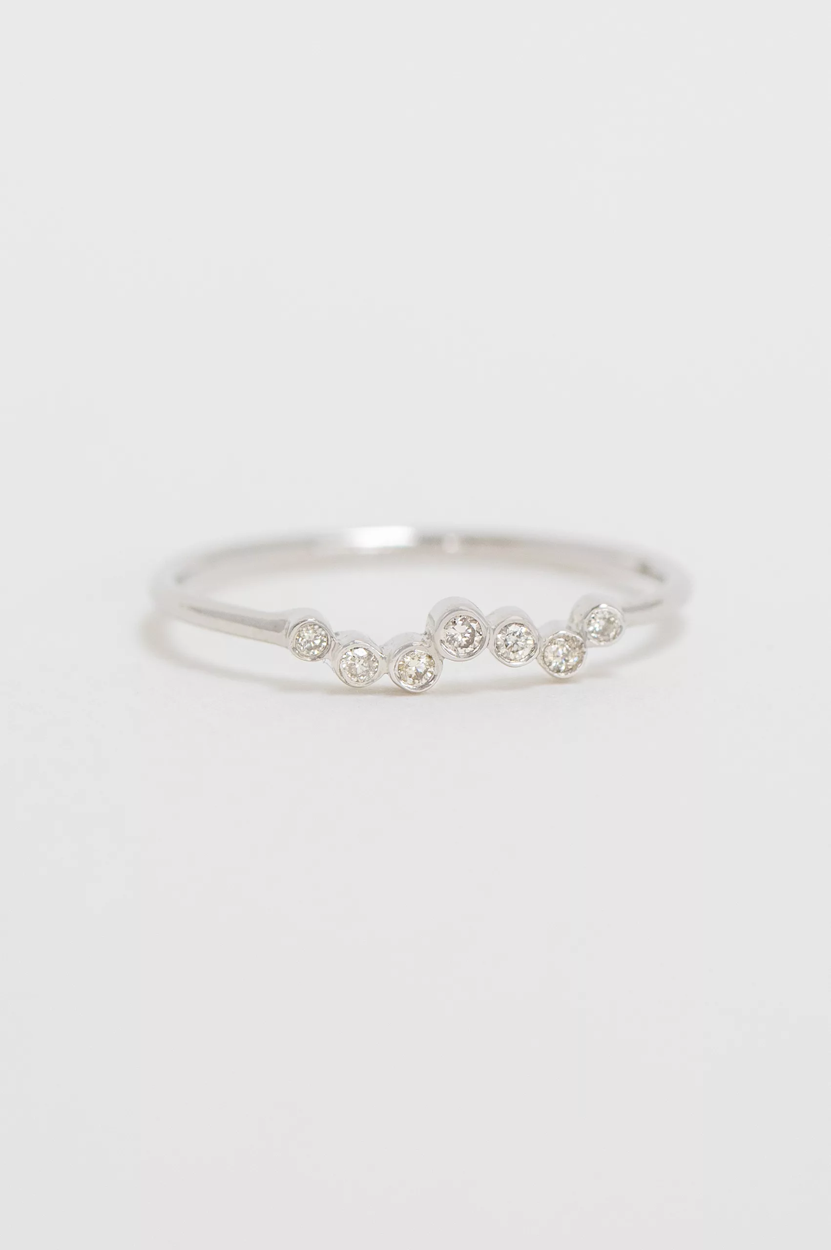 white gold ring with a twisted band design set with a continuous row of round brilliant diamonds along a delicate twisted wire