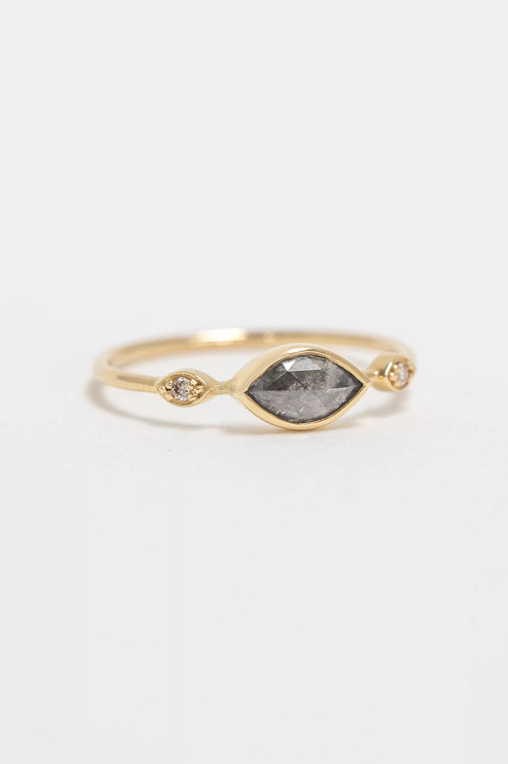 Yellow gold ring oval grey diamond two diamond eye accent slim band worn on hand Celine Daoust