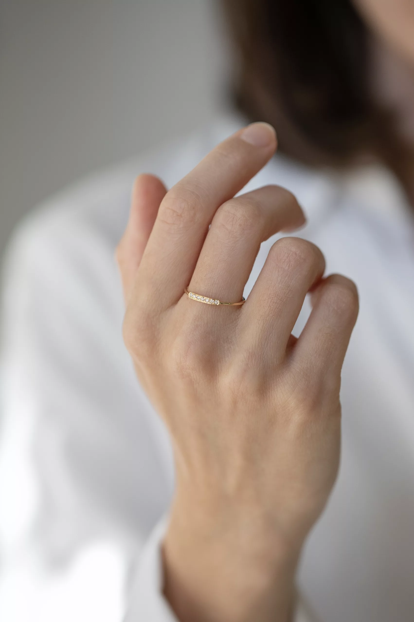 Yellow gold slim band ring multiple small bezel-set diamonds bar Celine Daoust