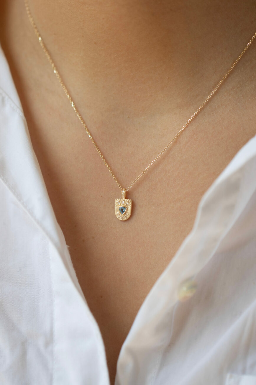 Yellow gold necklace engraved shield pendant trillion aquamarine diamond sun motif Celine Daoust