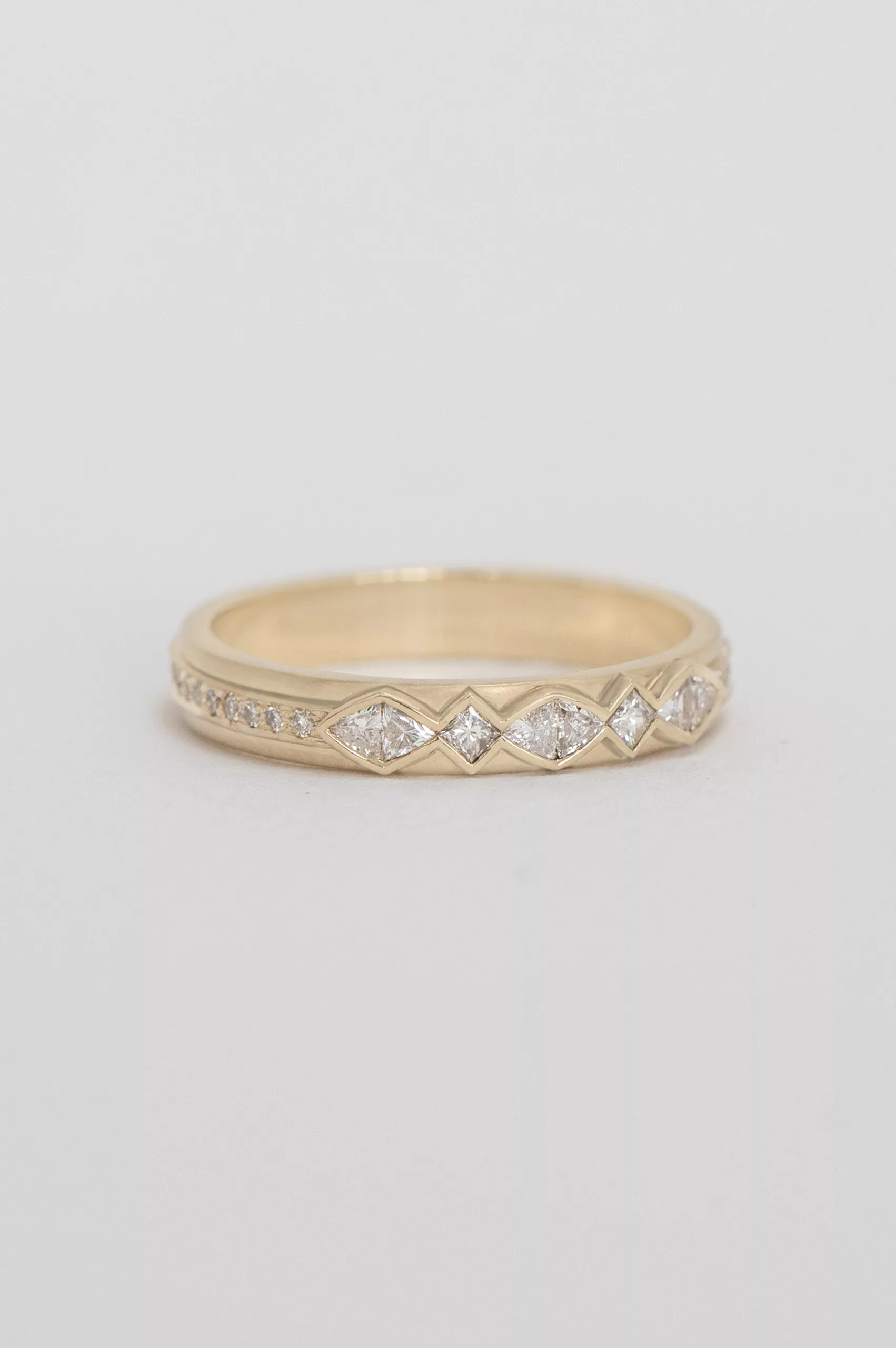 Yellow gold band ring multiple trillion-cut diamonds geometric setting Celine Daoust