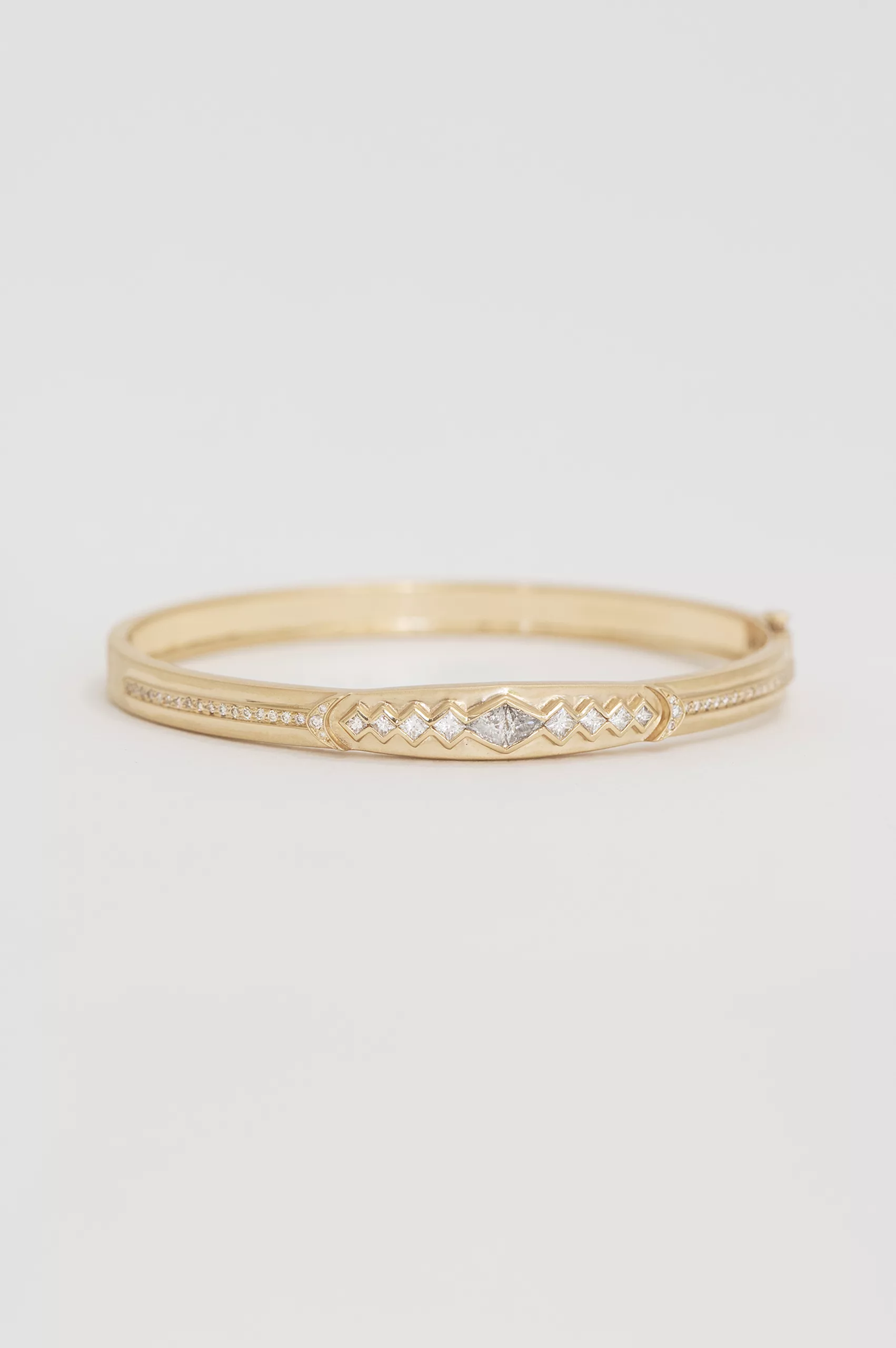 Gold bangle bracelet diamond triangle motifs pave diamond line Celine Daoust