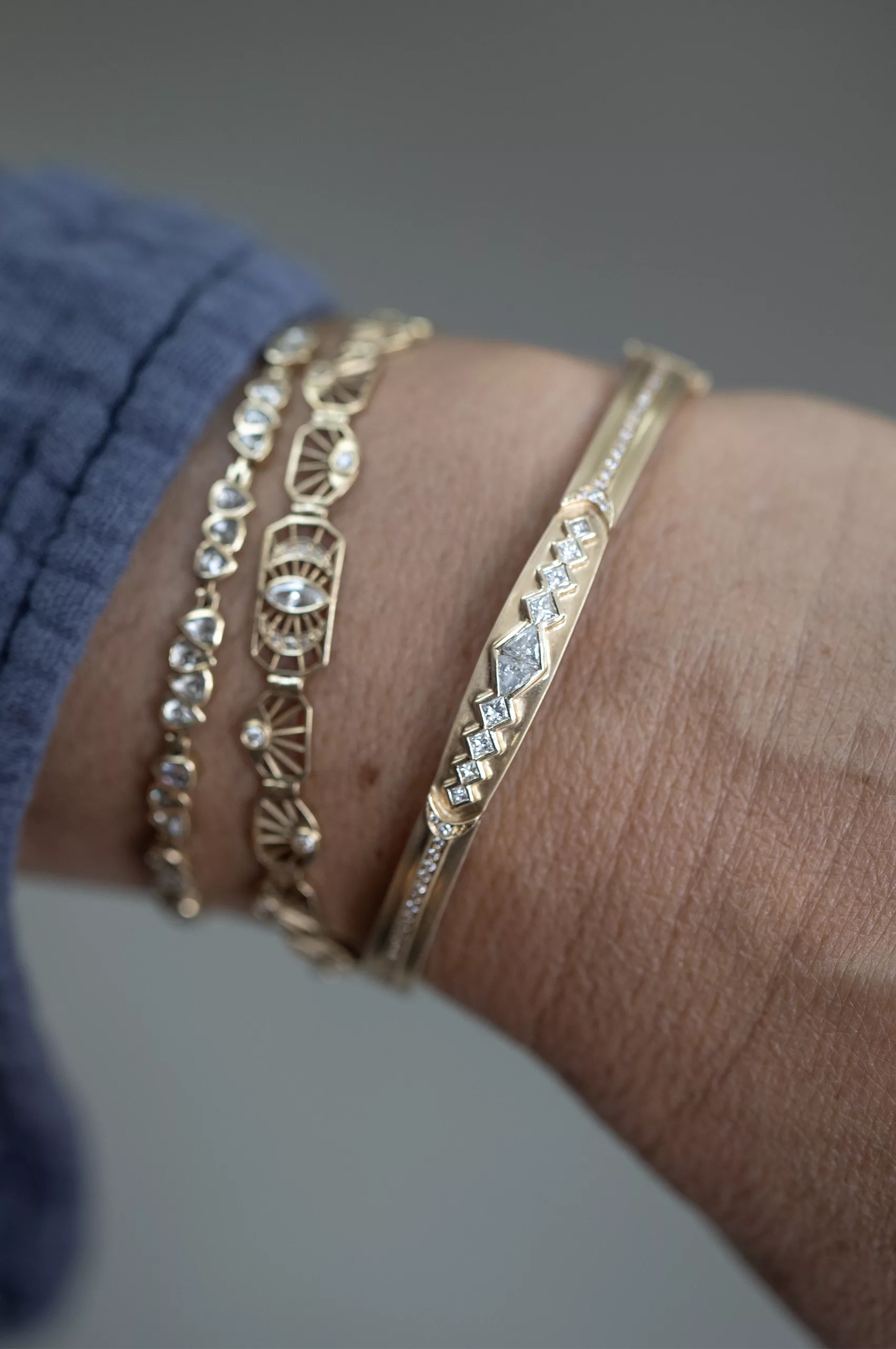 Gold bangle bracelet diamond triangle motifs pave diamond line Celine Daoust