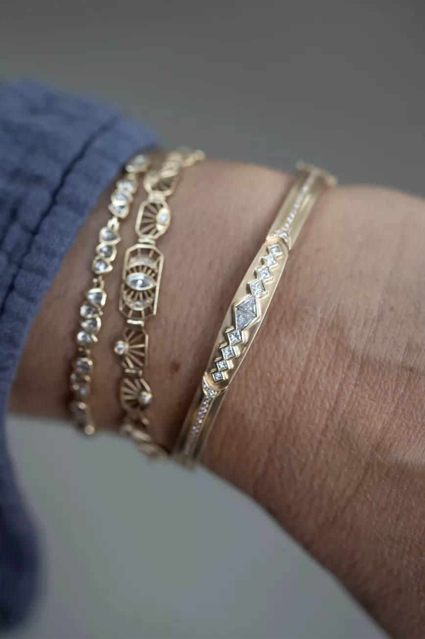 Gold bangle bracelet diamond triangle motifs pave diamond line Celine Daoust