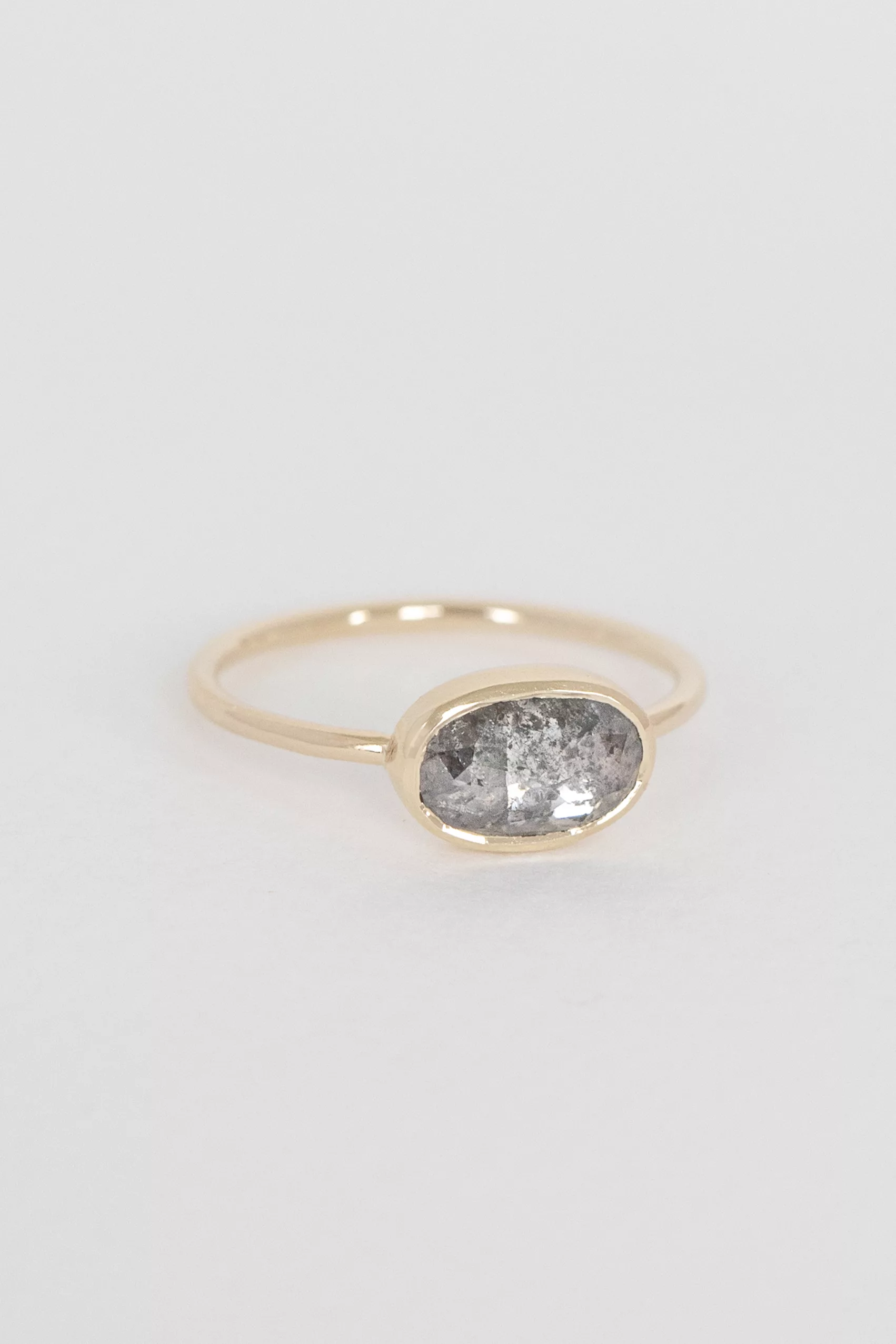 Yellow gold ring large oval grey diamond open bezel slim band Celine Daoust