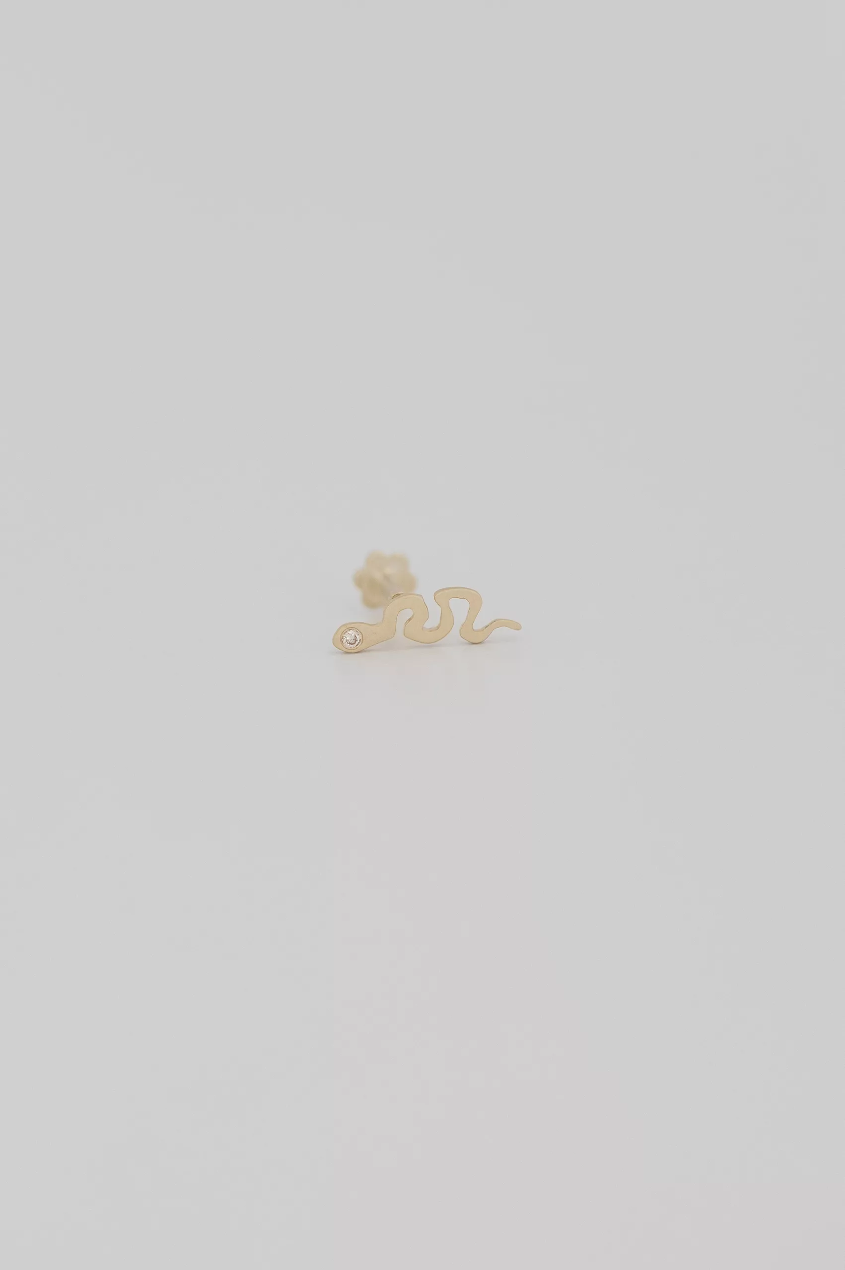 Yellow gold flat back piercing sculpted snake motif stud Celine Daoust