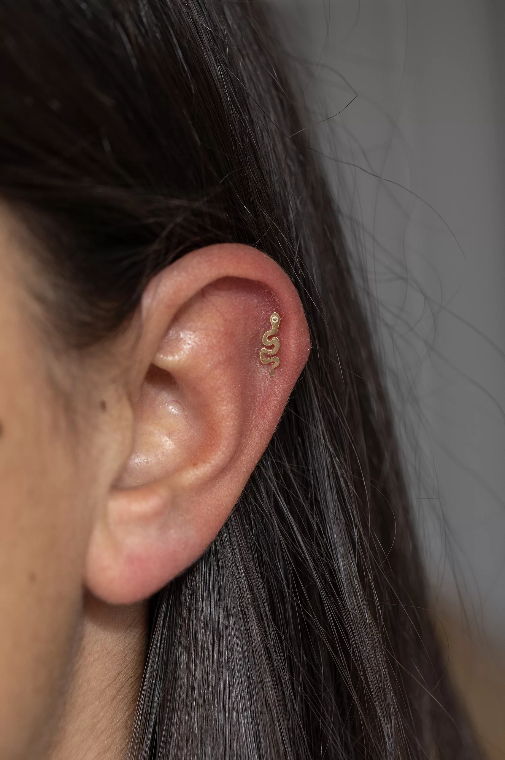 Yellow gold flat back piercing sculpted snake motif stud Celine Daoust