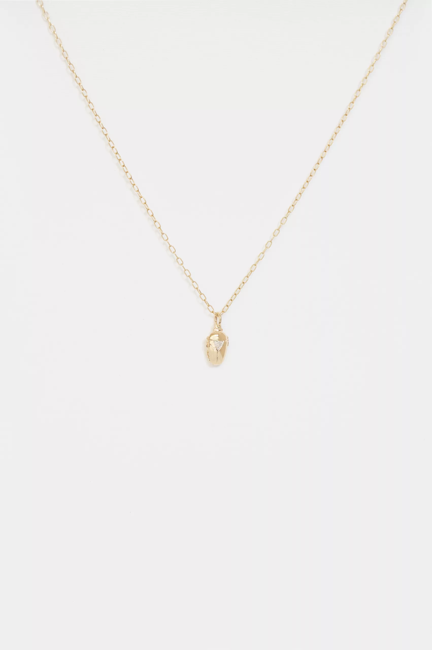 Yellow gold necklace small sculpted scarab pendant trillion diamond accent chain Celine Daoust