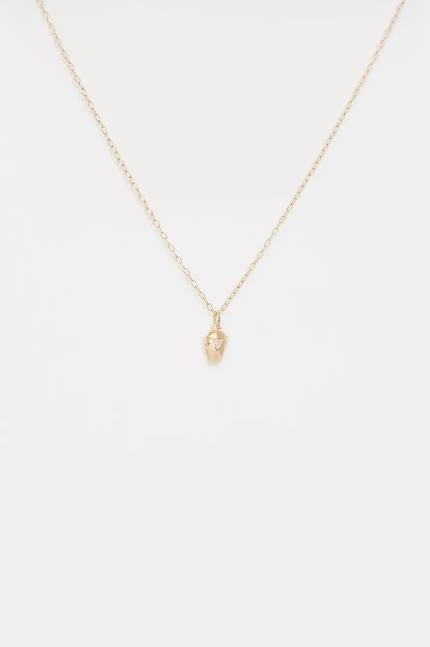 Yellow gold necklace small sculpted scarab pendant trillion diamond accent chain Celine Daoust