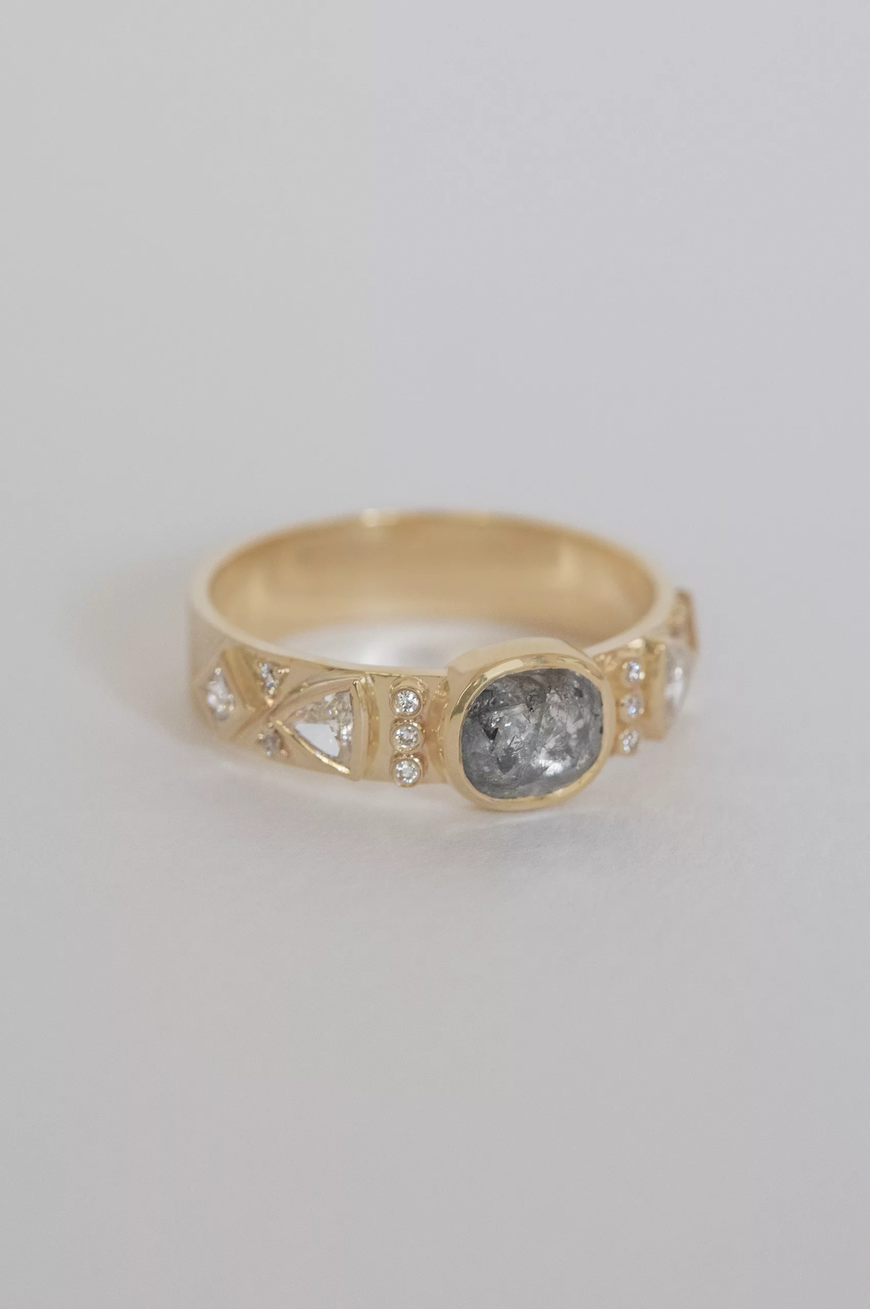 Gold band ring oval grey diamond triangle diamond side accents Celine Daoust