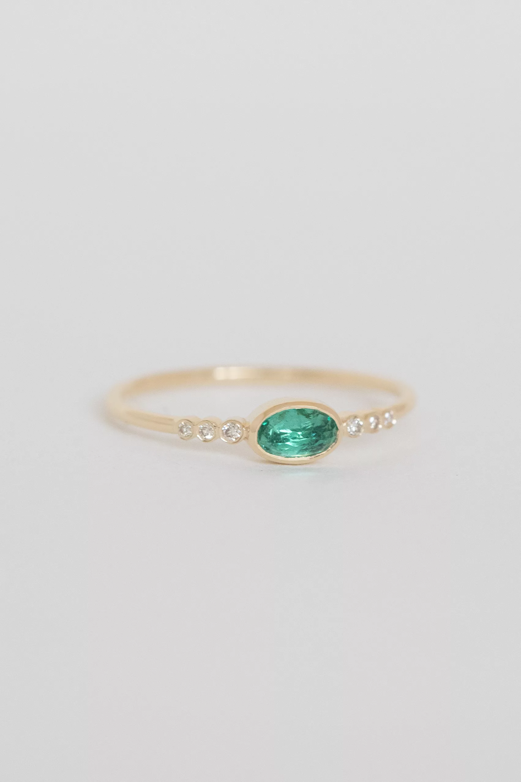 Yellow gold ring oval emerald diamond accent band Celine Daoust