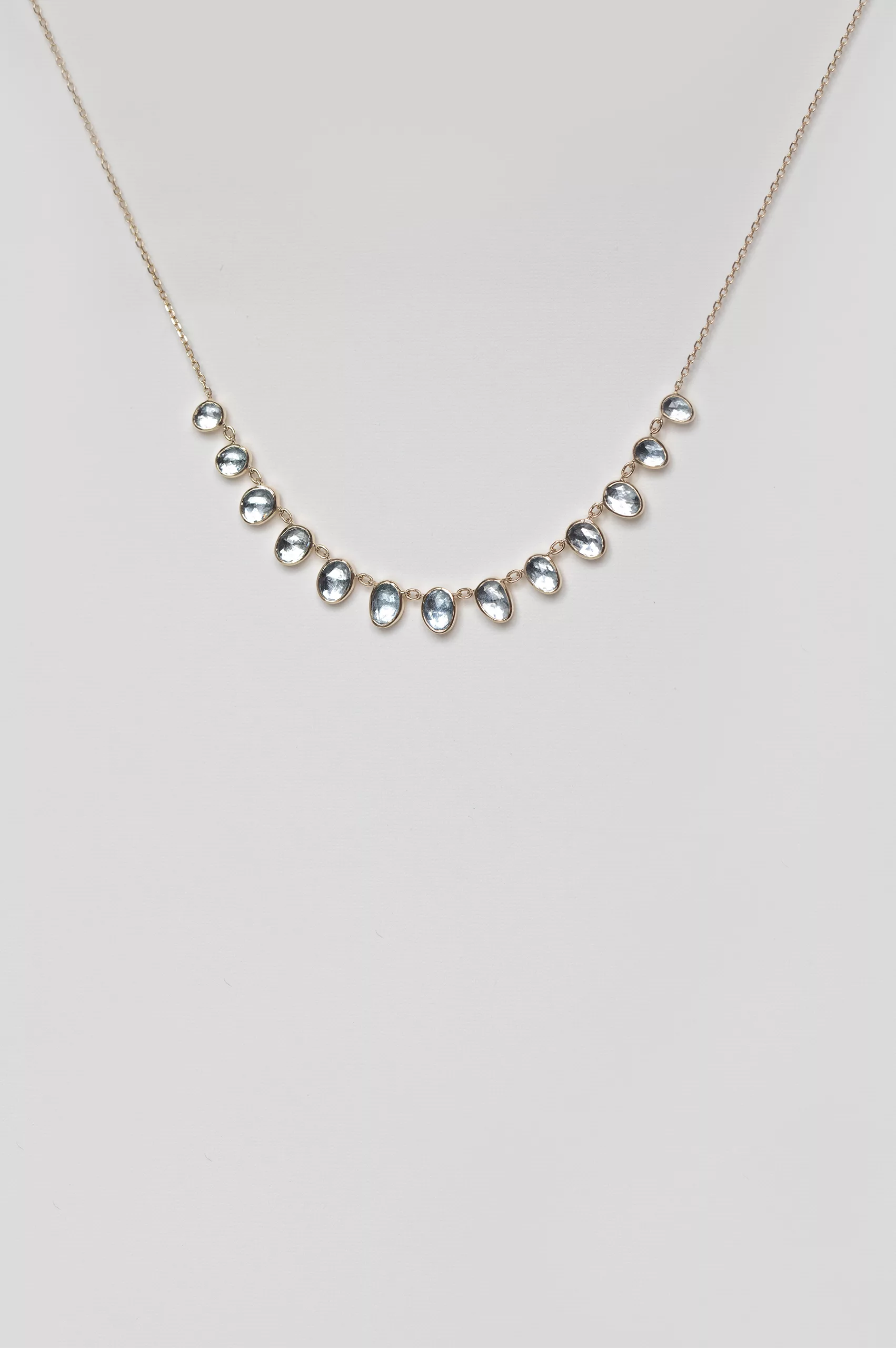 Yellow gold necklace multiple oval aquamarine bezel drops curved chain Celine Daoust