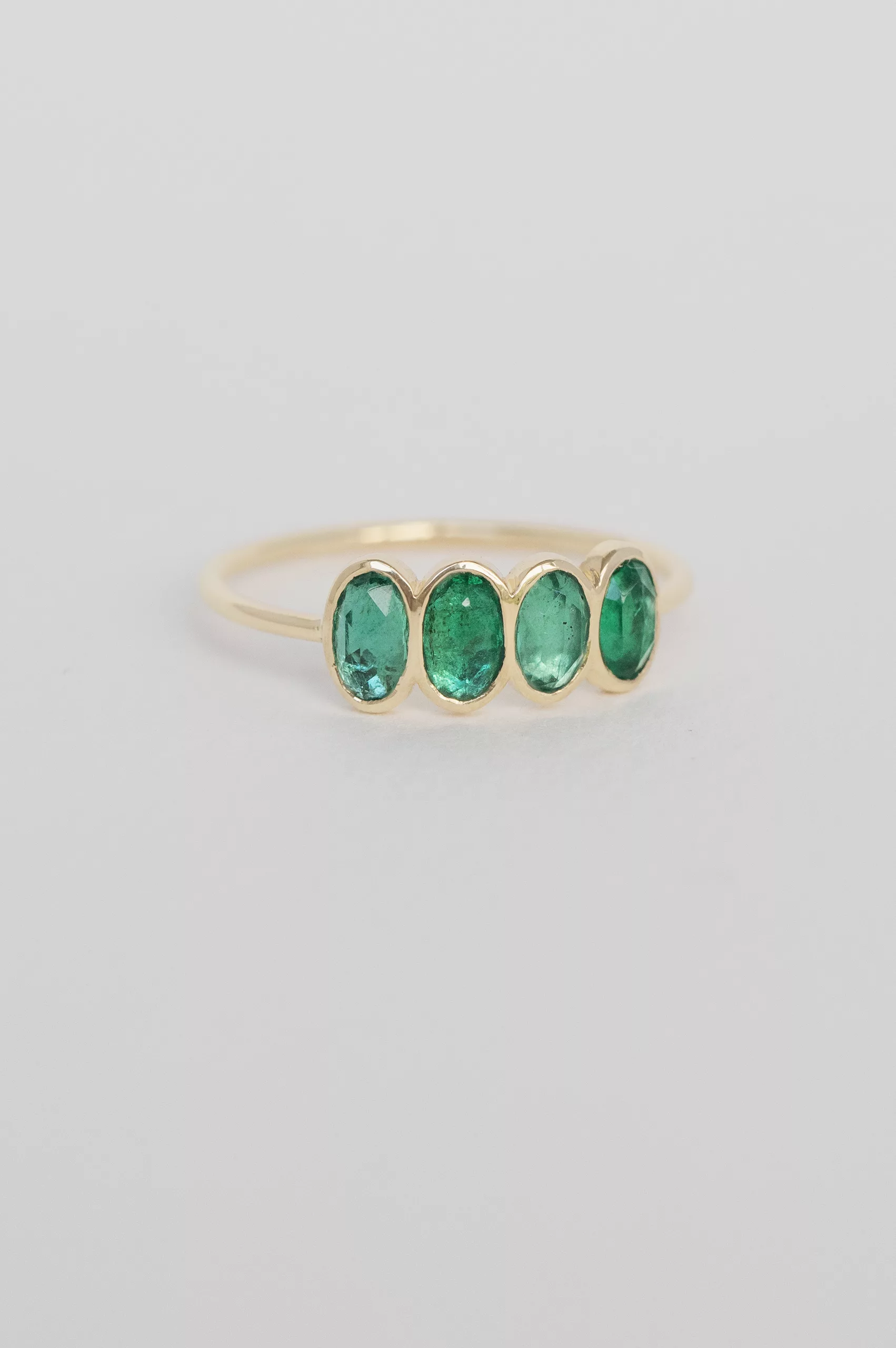 Yellow gold ring four oval emerald bezel set band Celine Daoust