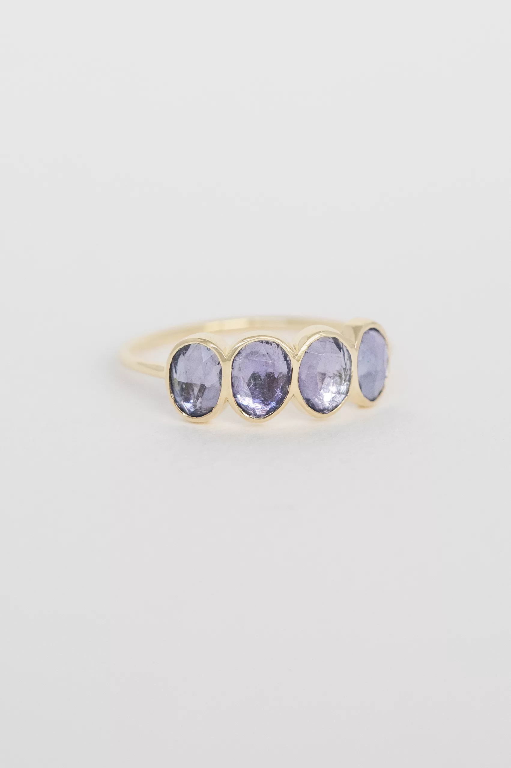 Yellow gold ring four oval tanzanite bezel set band Celine Daoust