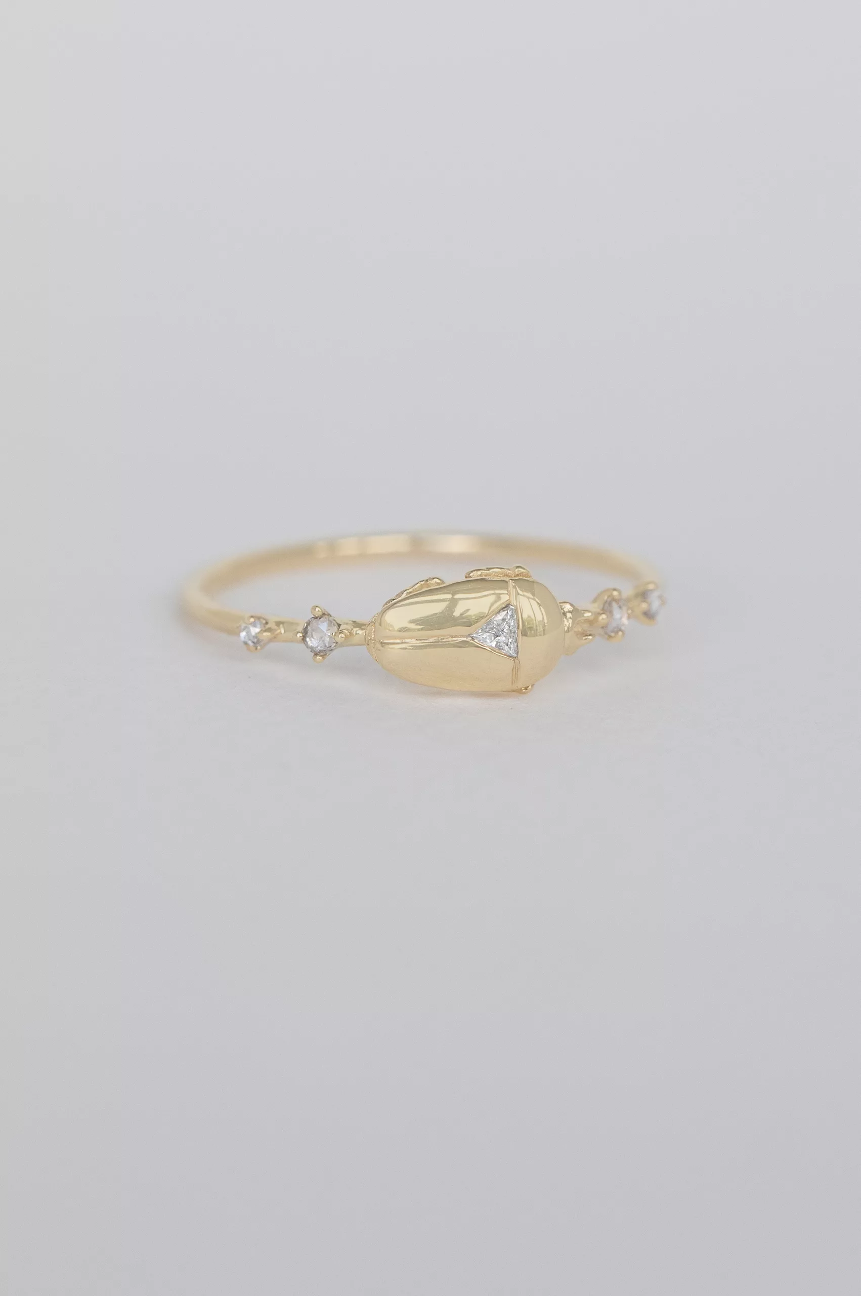 Gold ring sculpted scarab motif diamond accents Céline Daoust