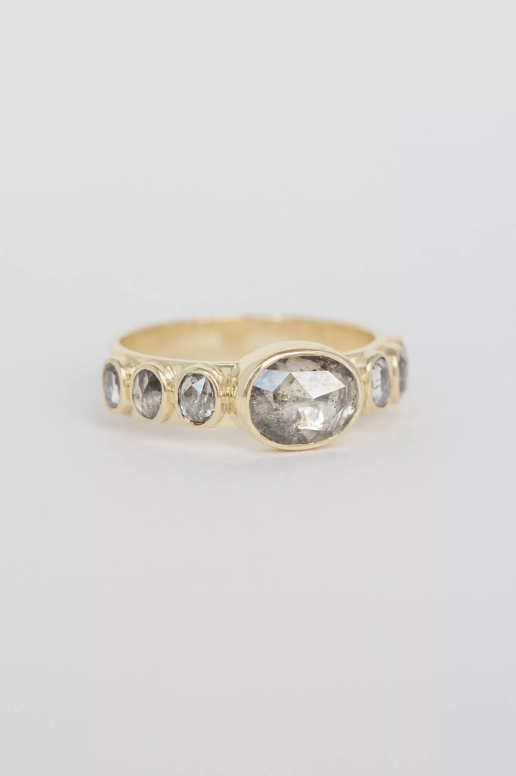 Yellow gold wide band ring oval grey diamond six grey diamond accents Celine Daoust