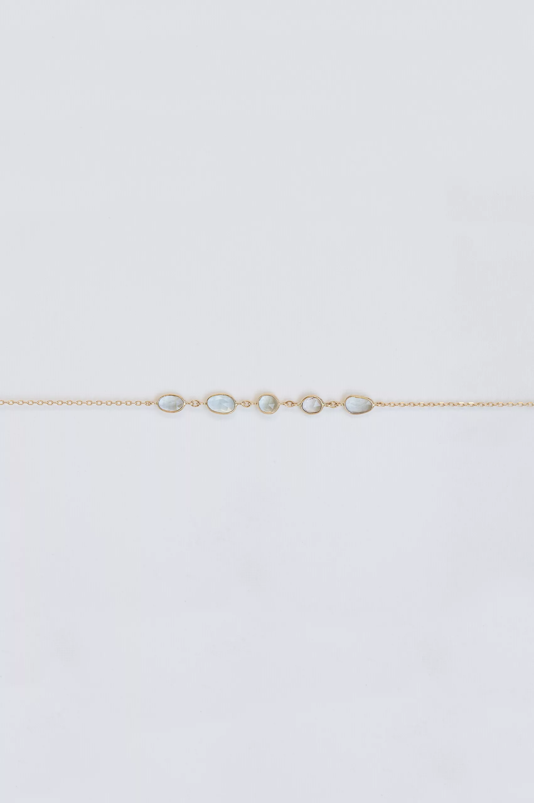 Yellow gold chain bracelet multiple oval blue tourmaline bezel stations Celine Daoust