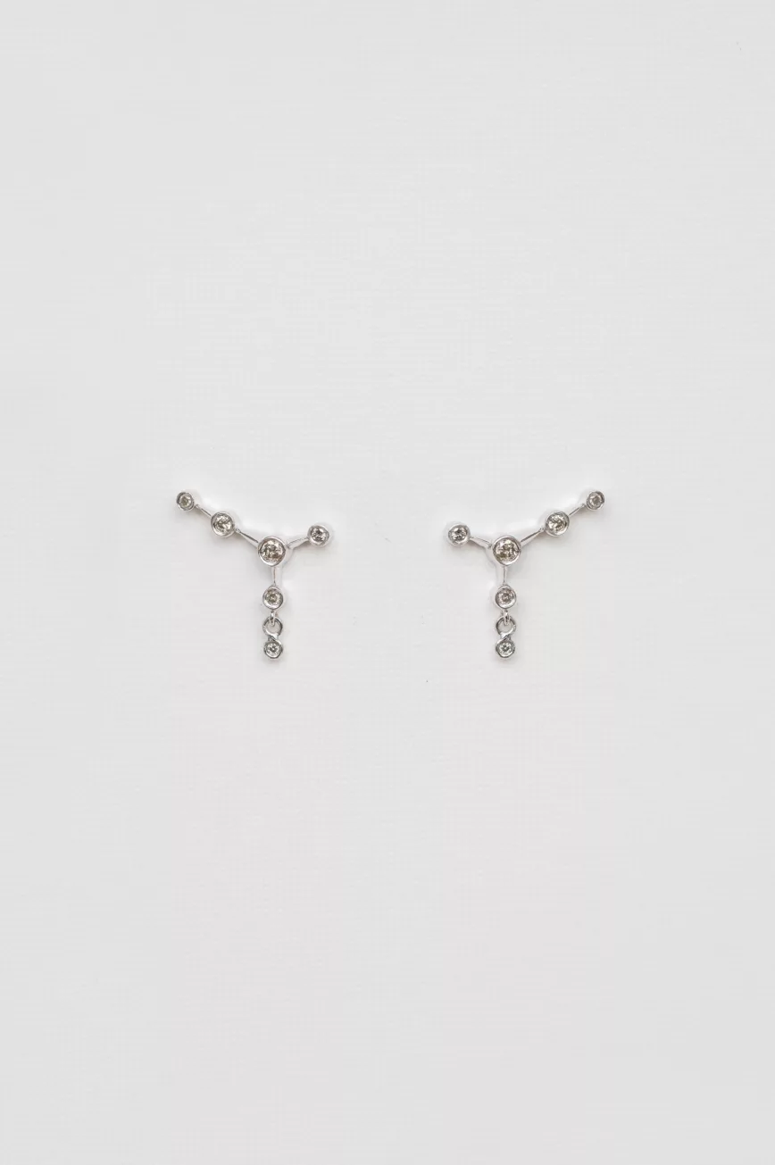 white gold ear jacket earrings featuring a constellation of diamonds along the lobe with a small dangling diamond drop below