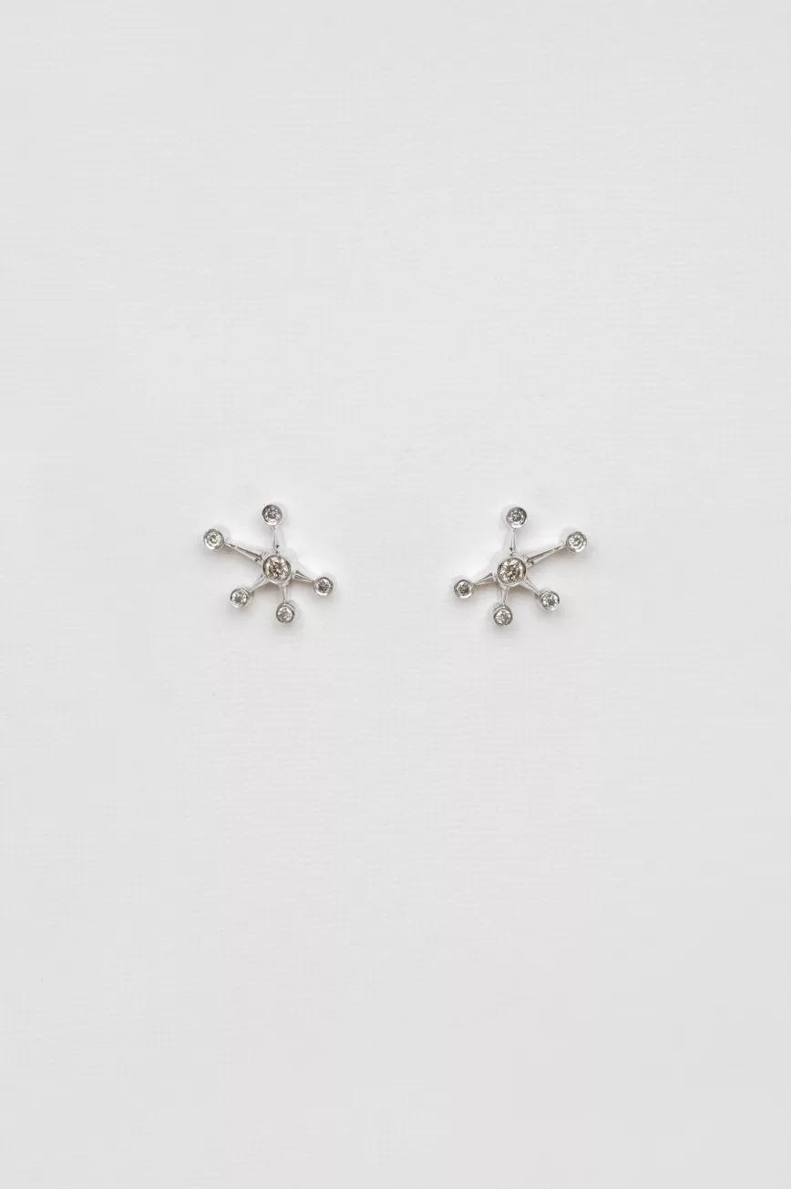 white gold stud earrings each shaped as a starburst with six radiating arms tipped with round diamonds, evoking a constellation pattern